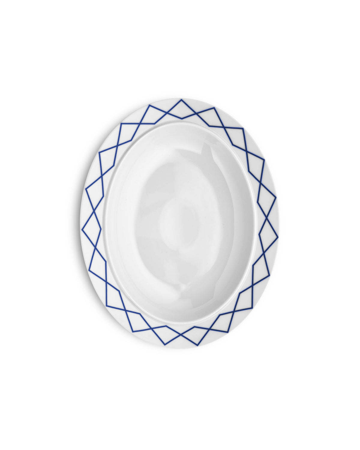 White serving plate by Alessi with a blue geometric pattern around the rim.