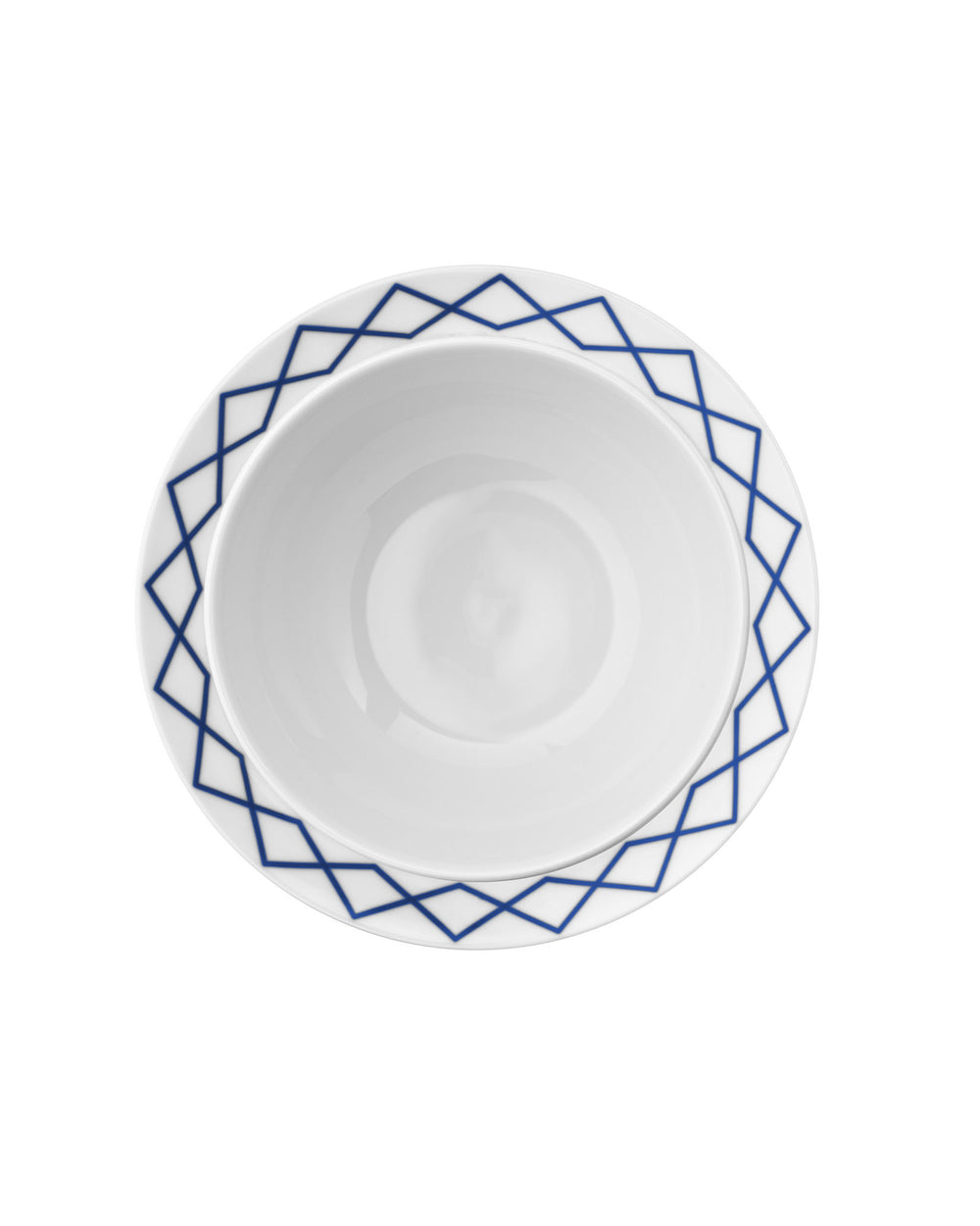 White ceramic salad serving bowl by Alessi, with a blue geometric diamond pattern around the rim, overhead view.