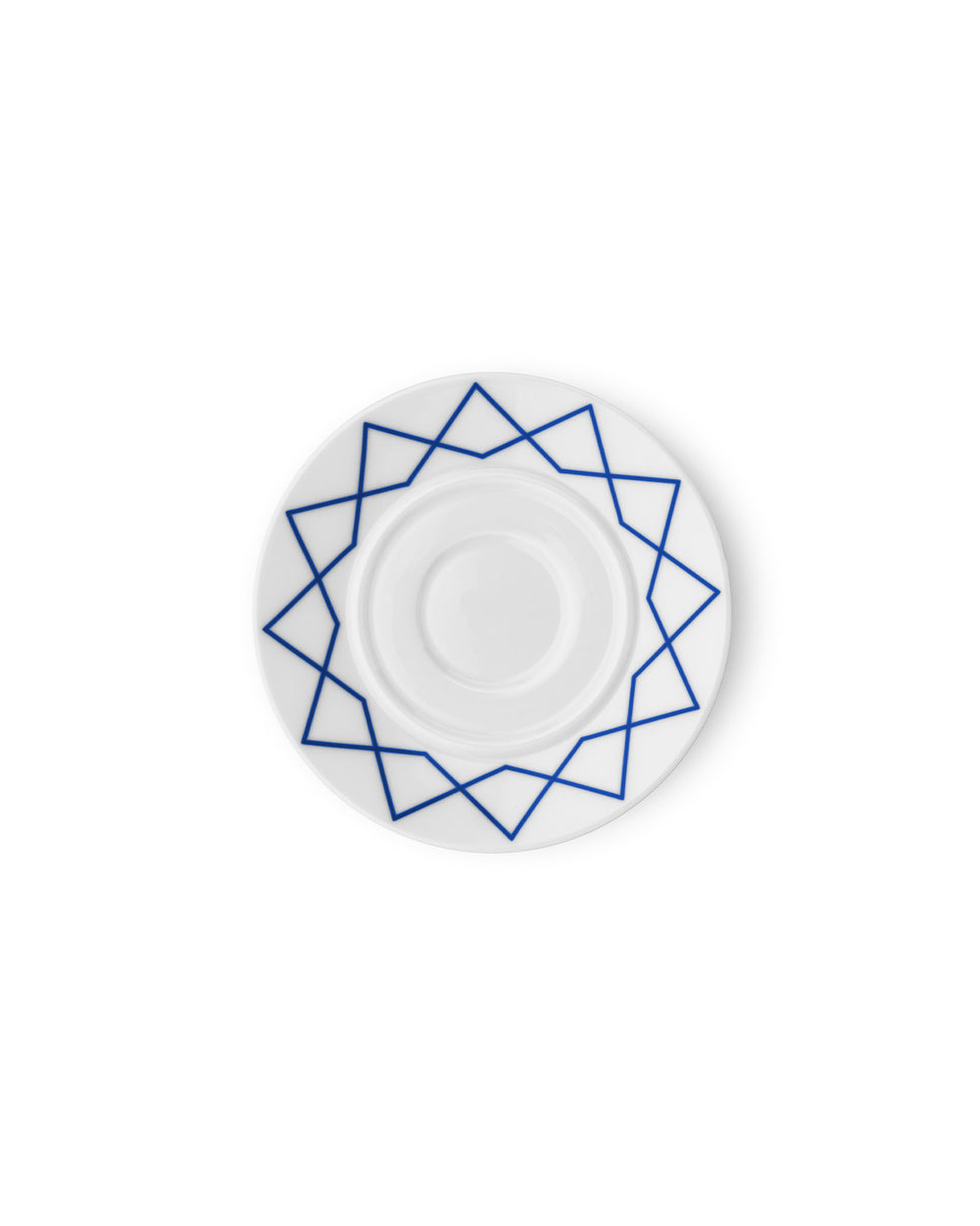 White porcelain saucer by Alessi with a blue geometric star pattern, shown from a top-down view.