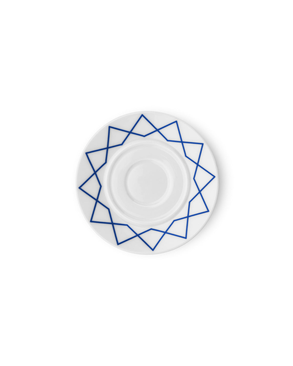 White porcelain saucer by Alessi with a blue geometric star pattern, shown from a top-down view.