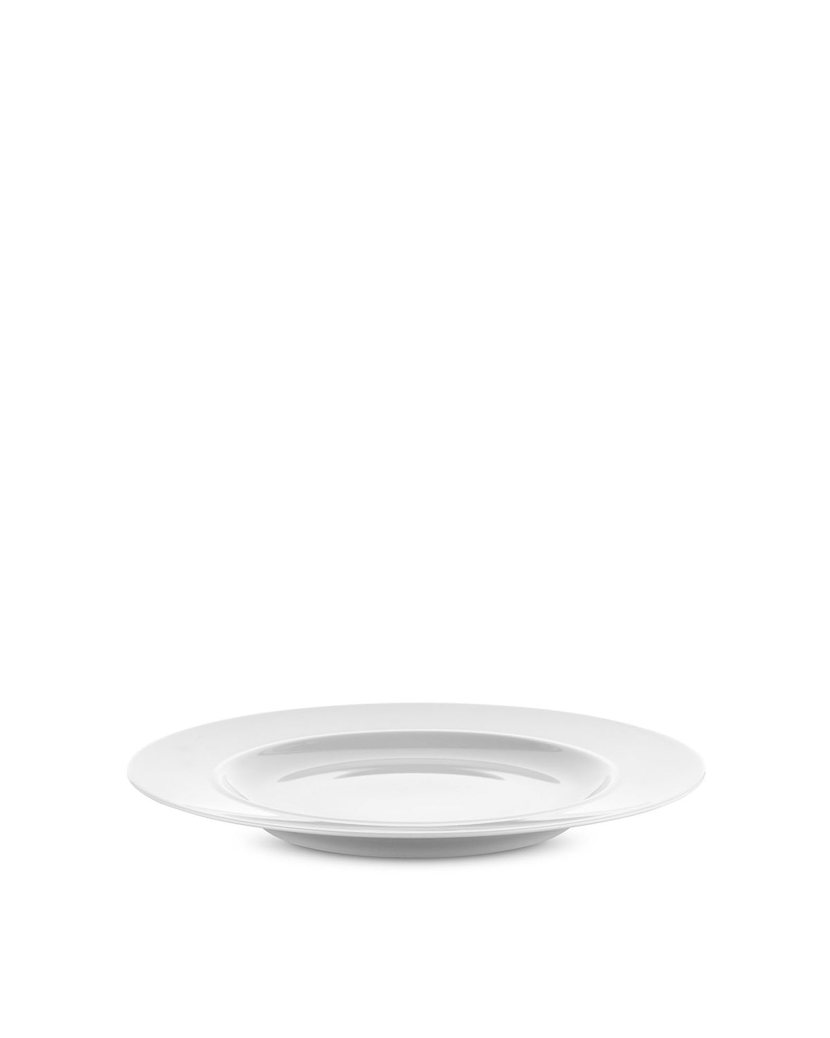 White dining plate by Alessi with a wide rim and deep center, seen from an angled side view.