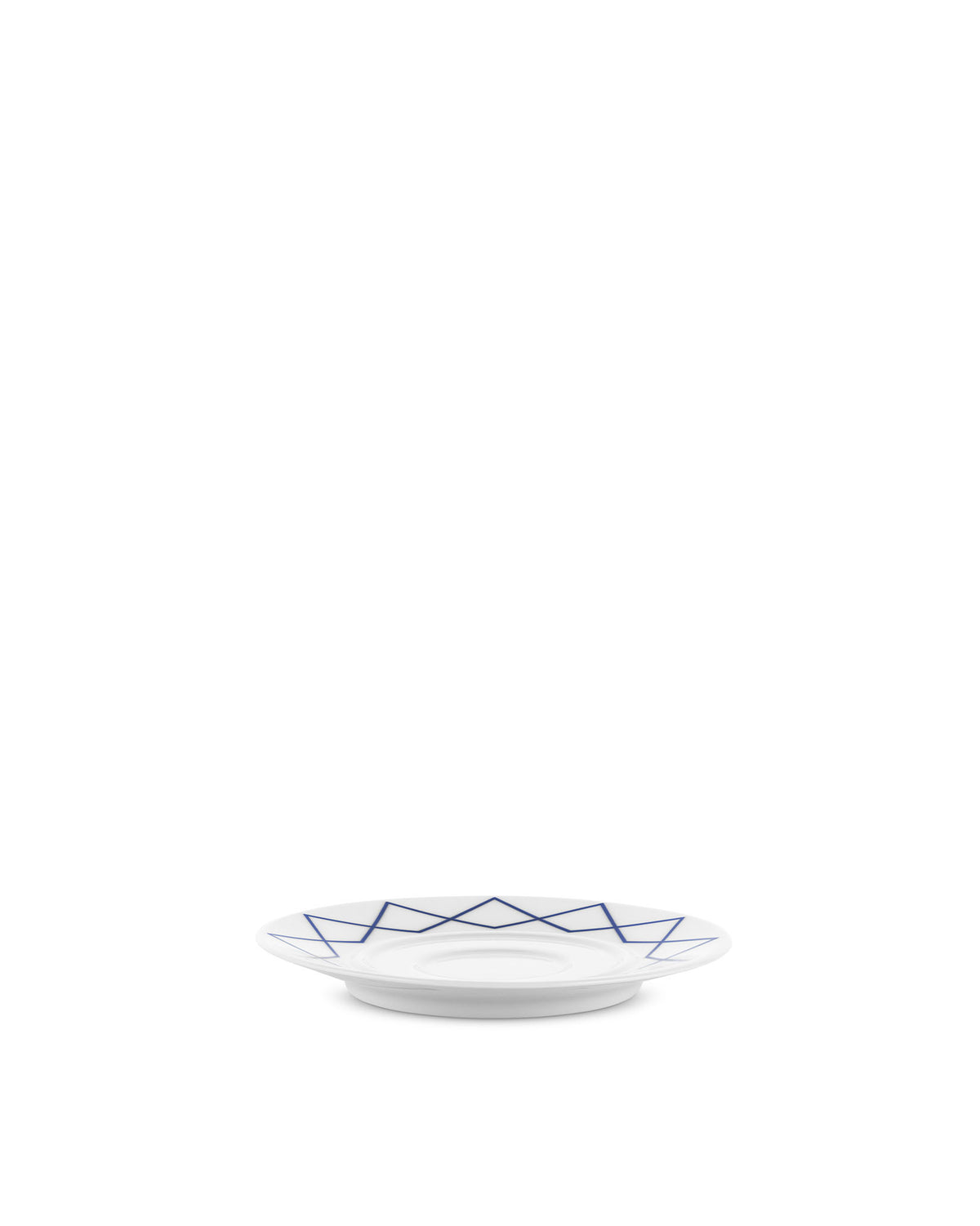 White porcelain saucer by Alessi with a blue geometric pattern, viewed from a low angle.