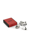 Sculptural metallic gift set by Alessi, featuring a red and black box and three abstractly shaped items.