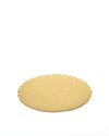 Gold metal tray by Alessi with a scalloped edge and embossed swirling pattern.