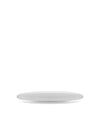White oval serving plate by Alessi, resting on a white surface at a slight angle.