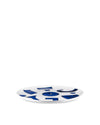 White plate by Alessi featuring a scattered blue abstract pattern.