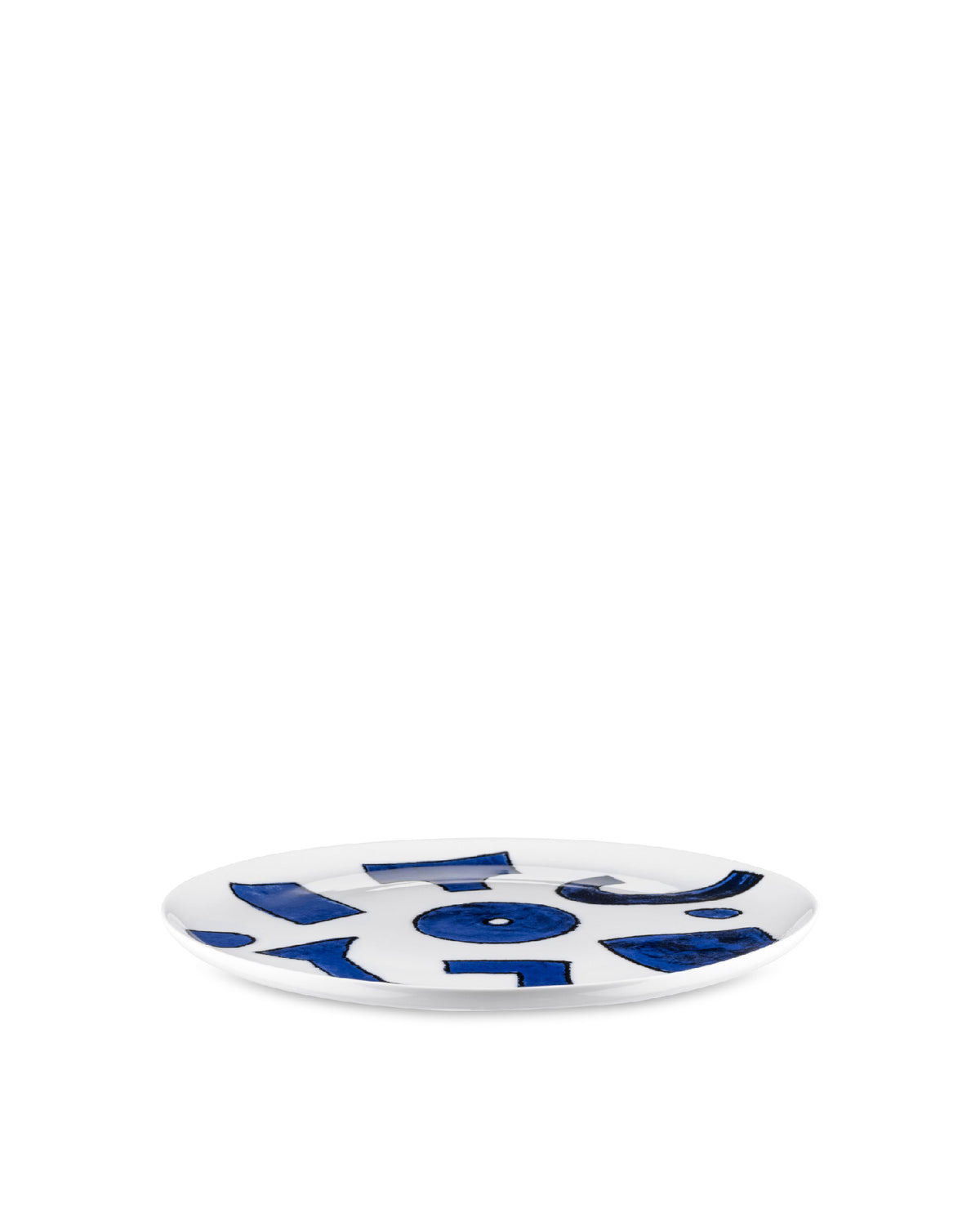 White plate by Alessi featuring a scattered blue abstract pattern.