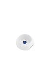 White ceramic dog bowl by Alessi, featuring a deep blue eye-like circle at its base.