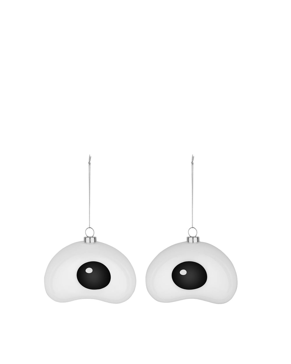 Two white and black fried egg Christmas tree ornaments by Alessi, suspended by silver chains.