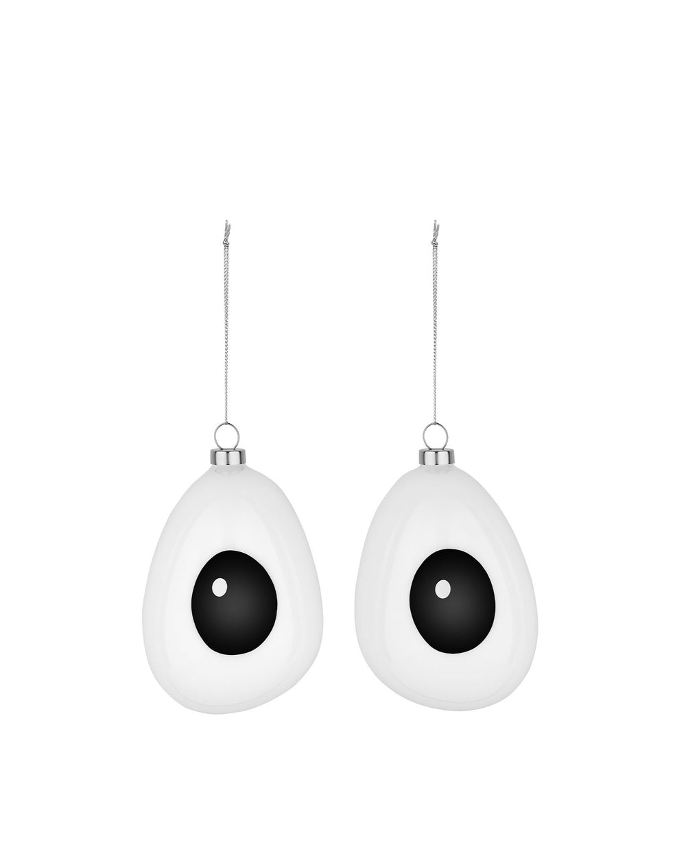 Two white, googly-eye shaped hanging decorations by Alessi, with black pupils and silver chains.
