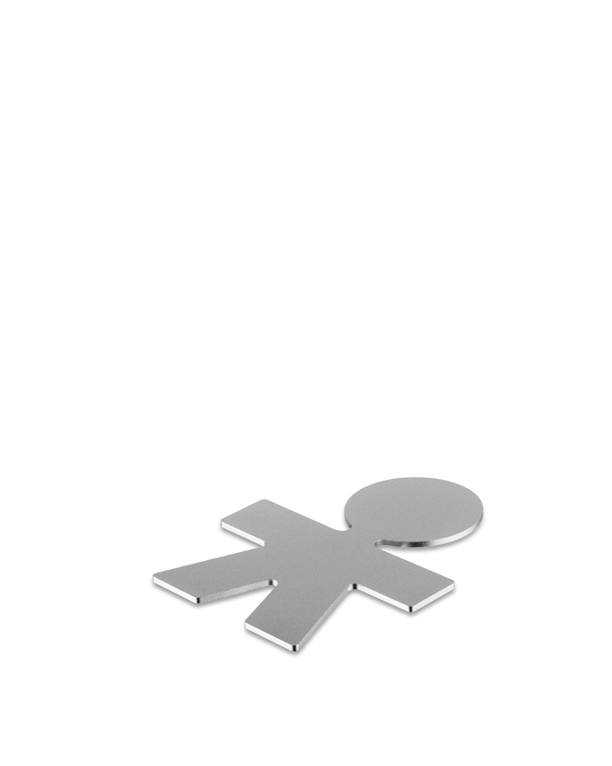 Silver metal trivet in a cutout human figure shape by Alessi, lying on a white surface.
