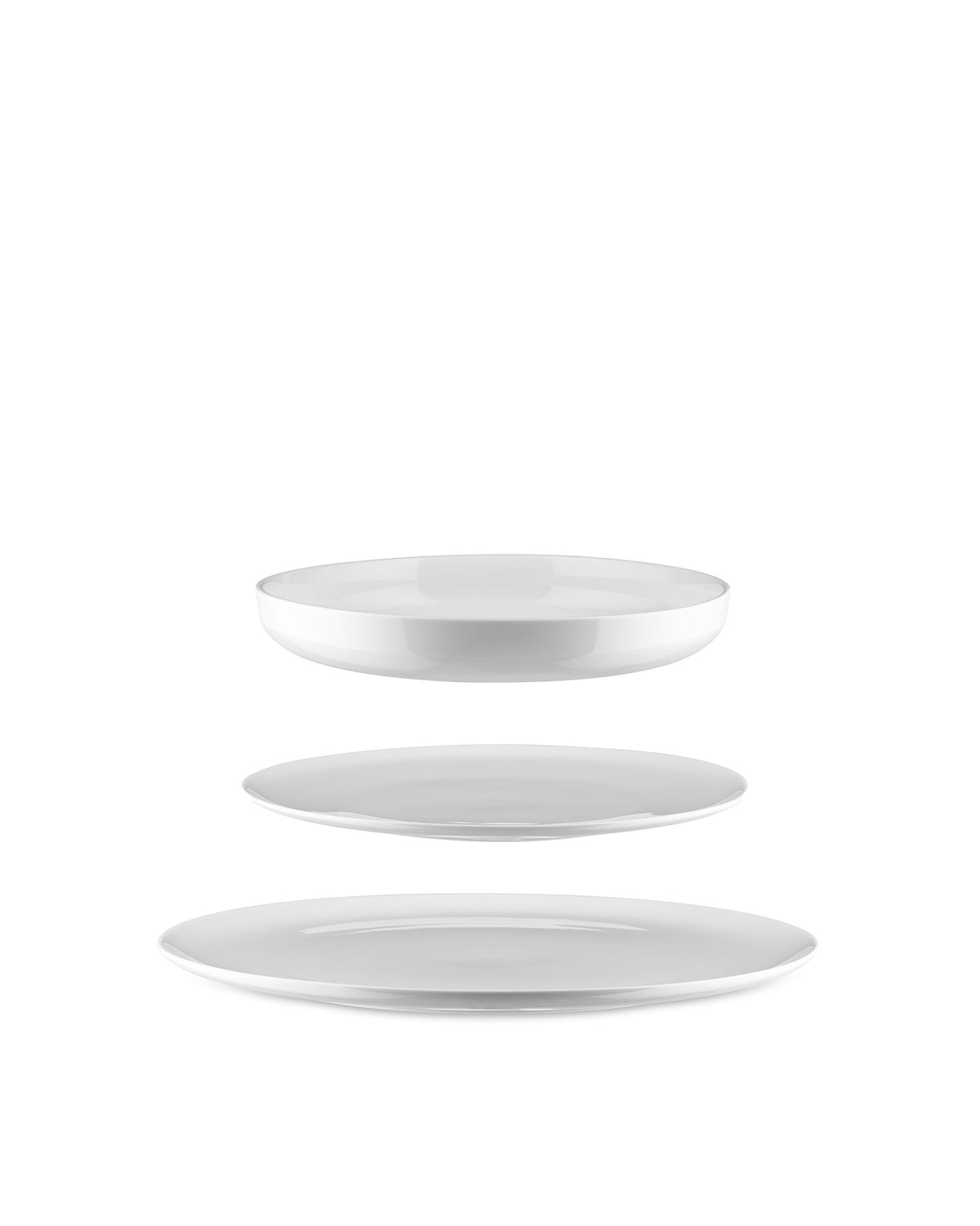 White ceramic table set by Alessi featuring a shallow bowl and two plates floating vertically.