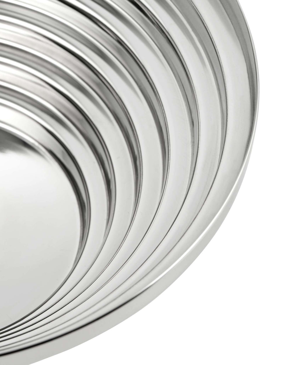 Silver metallic centerpiece bowl by Alessi featuring concentric curving ridges.