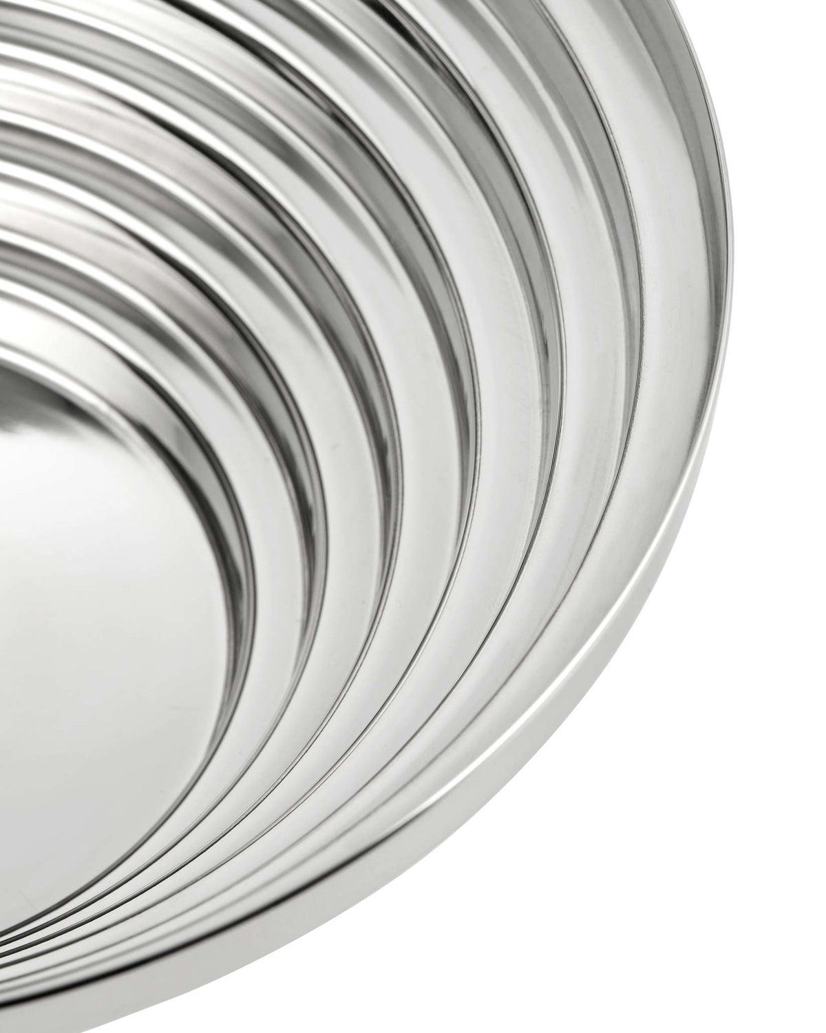 Silver metallic centerpiece bowl by Alessi featuring concentric curving ridges.