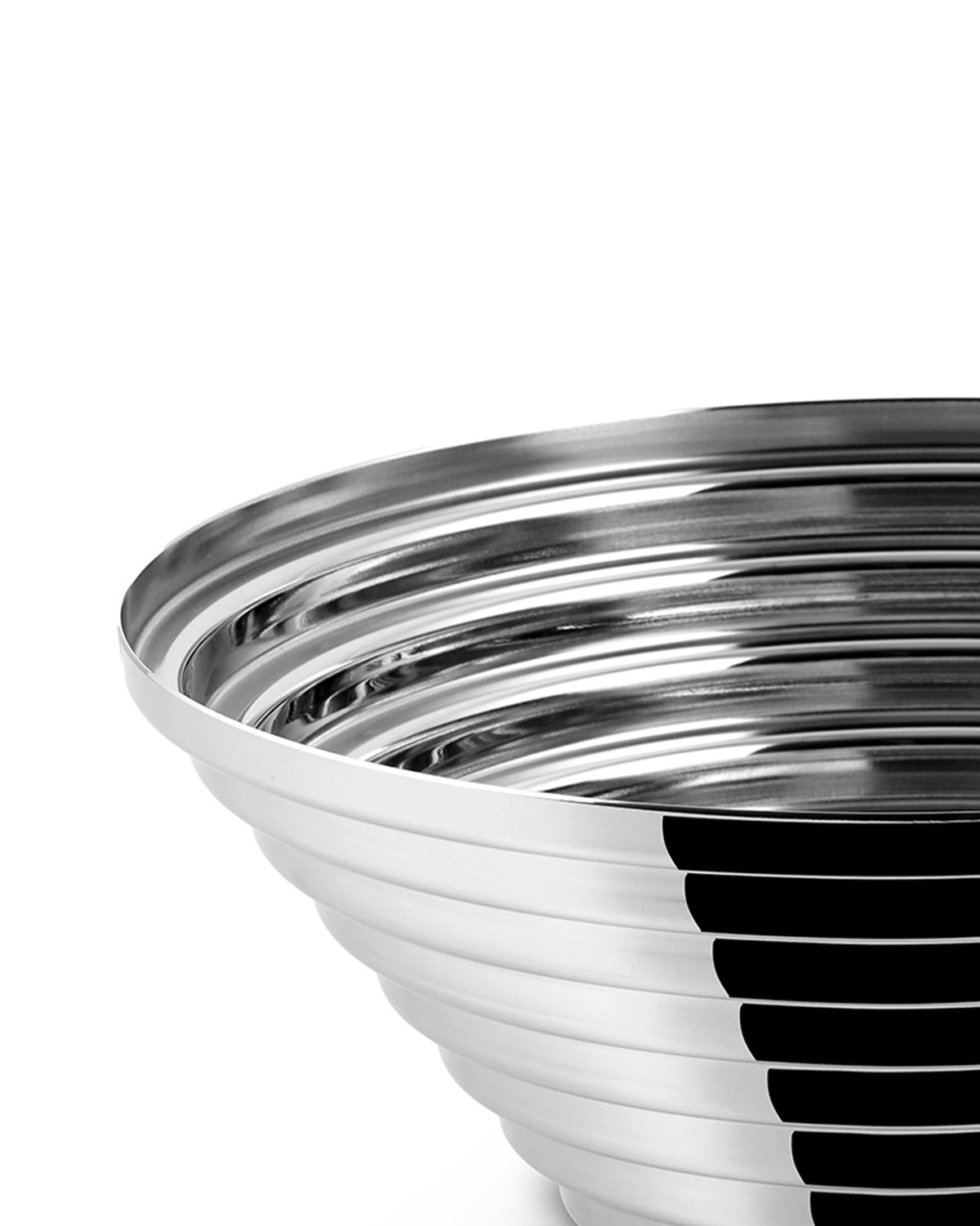 Silver metallic bowl by Alessi featuring a stepped, ribbed design and highly reflective surface, cropped view.