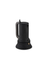 Black espresso coffee maker by Alessi, with a gray handle and a golden pressure valve.