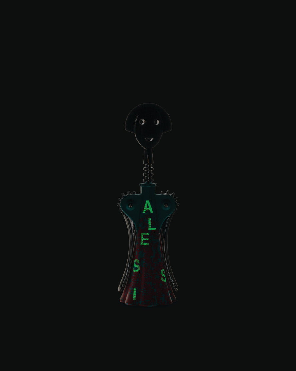 Black and dark teal Anna G. corkscrew by Alessi, an anthropomorphic design with glowing green 'ALESSI' text.