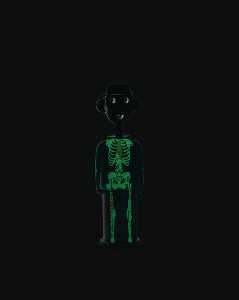 Black corkscrew with a glow-in-the-dark skeleton design by Alessi, styled as a smiling person wearing a hat.