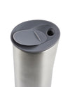 Brushed stainless steel Buri thermo tumbler by Alessi, with a dark grey flip-top lid and drinking hole, angled view.
