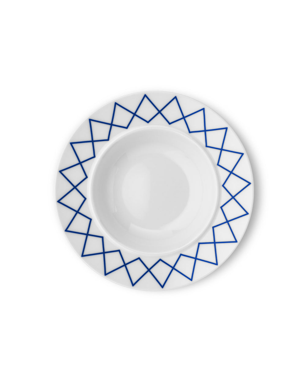 White ceramic soup bowl by Alessi with a blue geometric zigzag pattern around the rim, viewed from above.