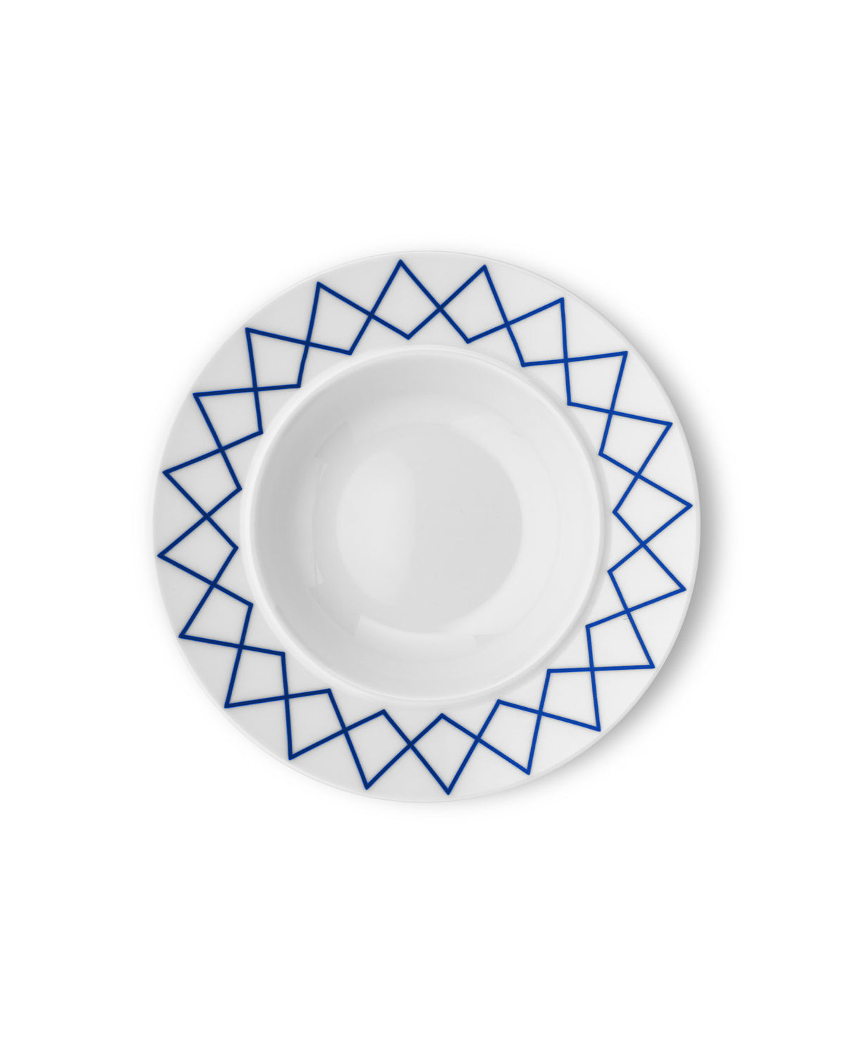 White ceramic soup bowl by Alessi with a blue geometric zigzag pattern around the rim, viewed from above.
