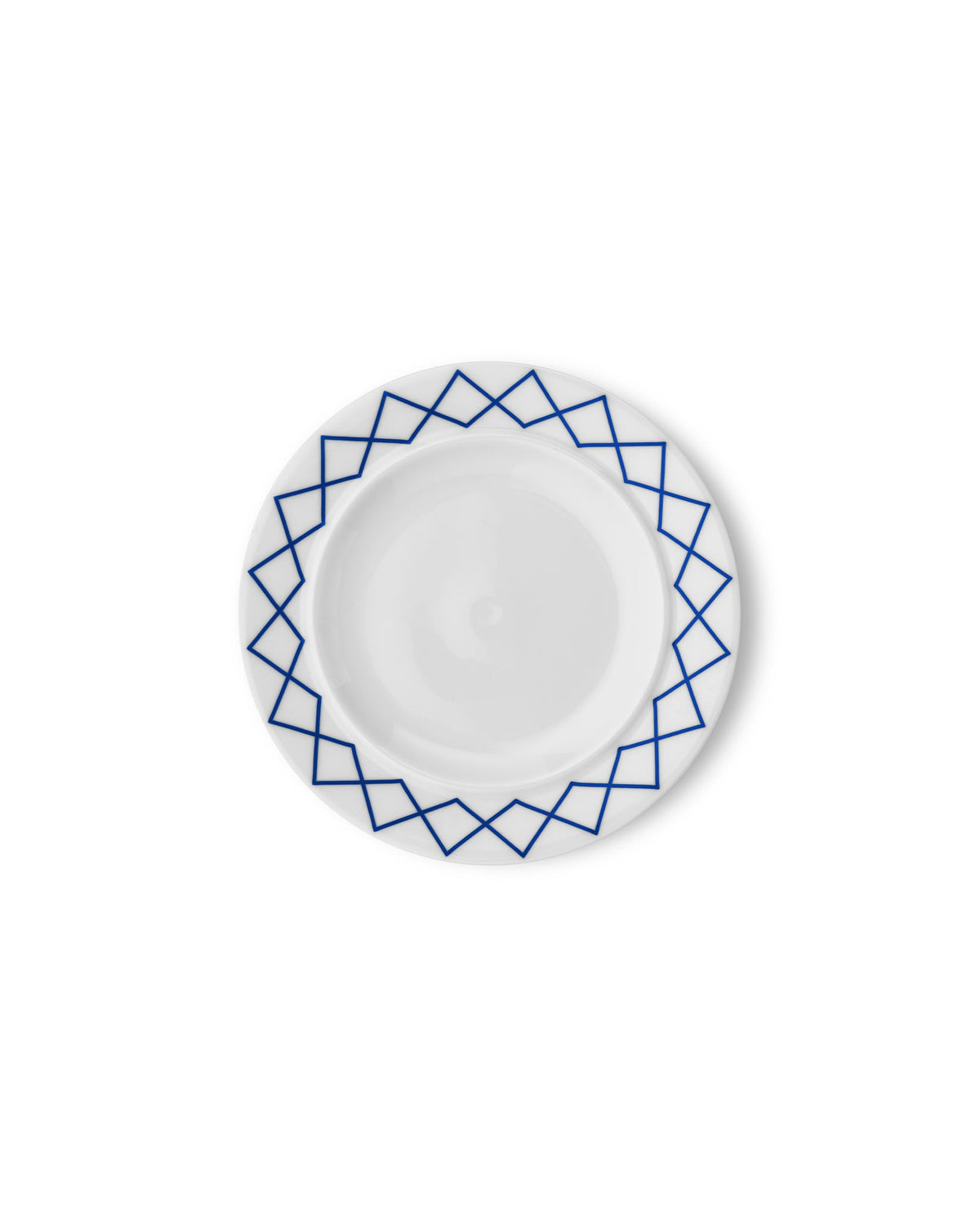 White side plate by Alessi with a blue geometric pattern along the rim, viewed from above.