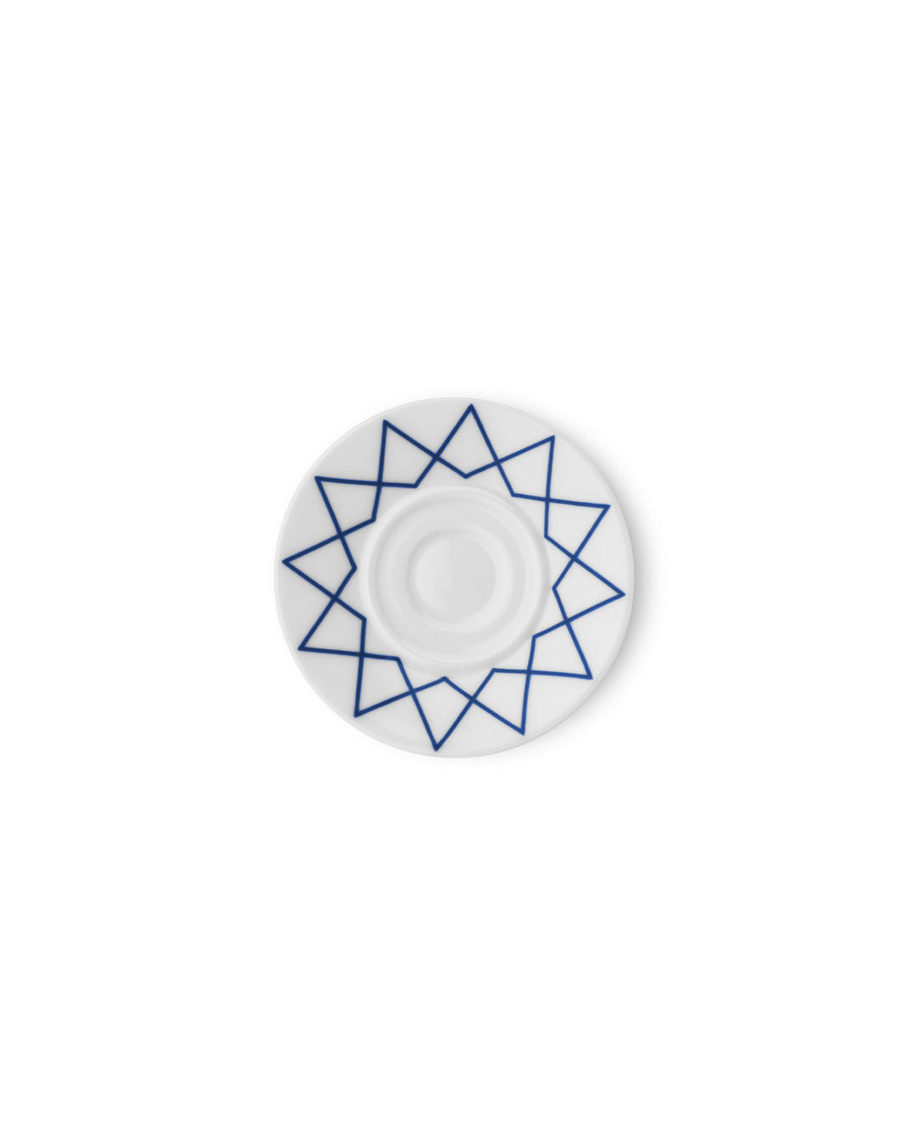 White saucer by Alessi with a blue geometric star pattern, viewed from above.