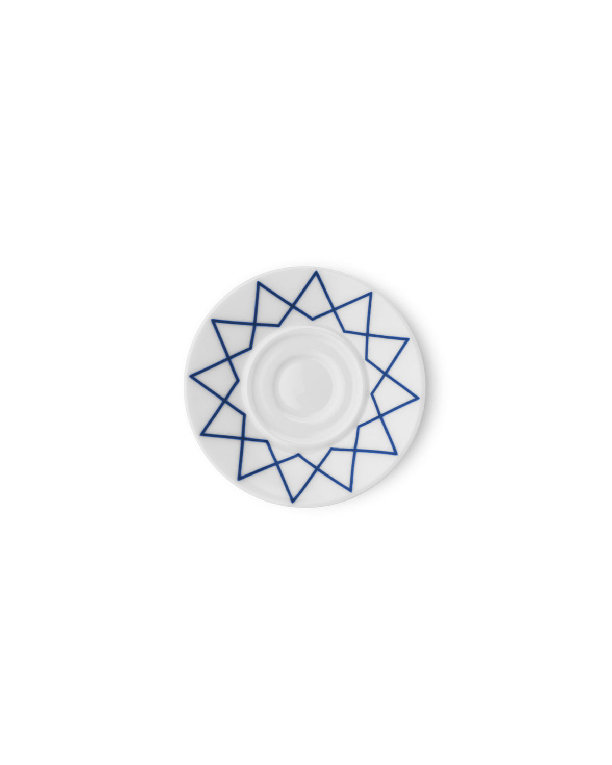 White saucer by Alessi with a blue geometric star pattern, viewed from above.
