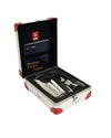 Silver cocktail shaker by Alessi, in an open white case with red corners, accompanied by jigger, tongs, and a recipe book.