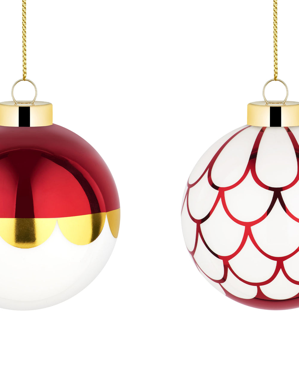 Two festive Christmas tree ornaments by Alessi: one metallic red and gold, one white with metallic red scallop patterns, both with gold caps.