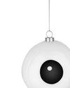 White eyeball Christmas tree ornament by Alessi with a black pupil, white highlight, and silver hanging chain.