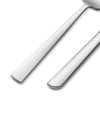 Polished silver flatware by Alessi, with sleek handles angled on a clean white background.
