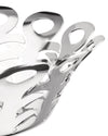 Silver perforated metal fruit holder by Alessi with an intricate, flowing cut-out design and a highly reflective surface, angled close-up.