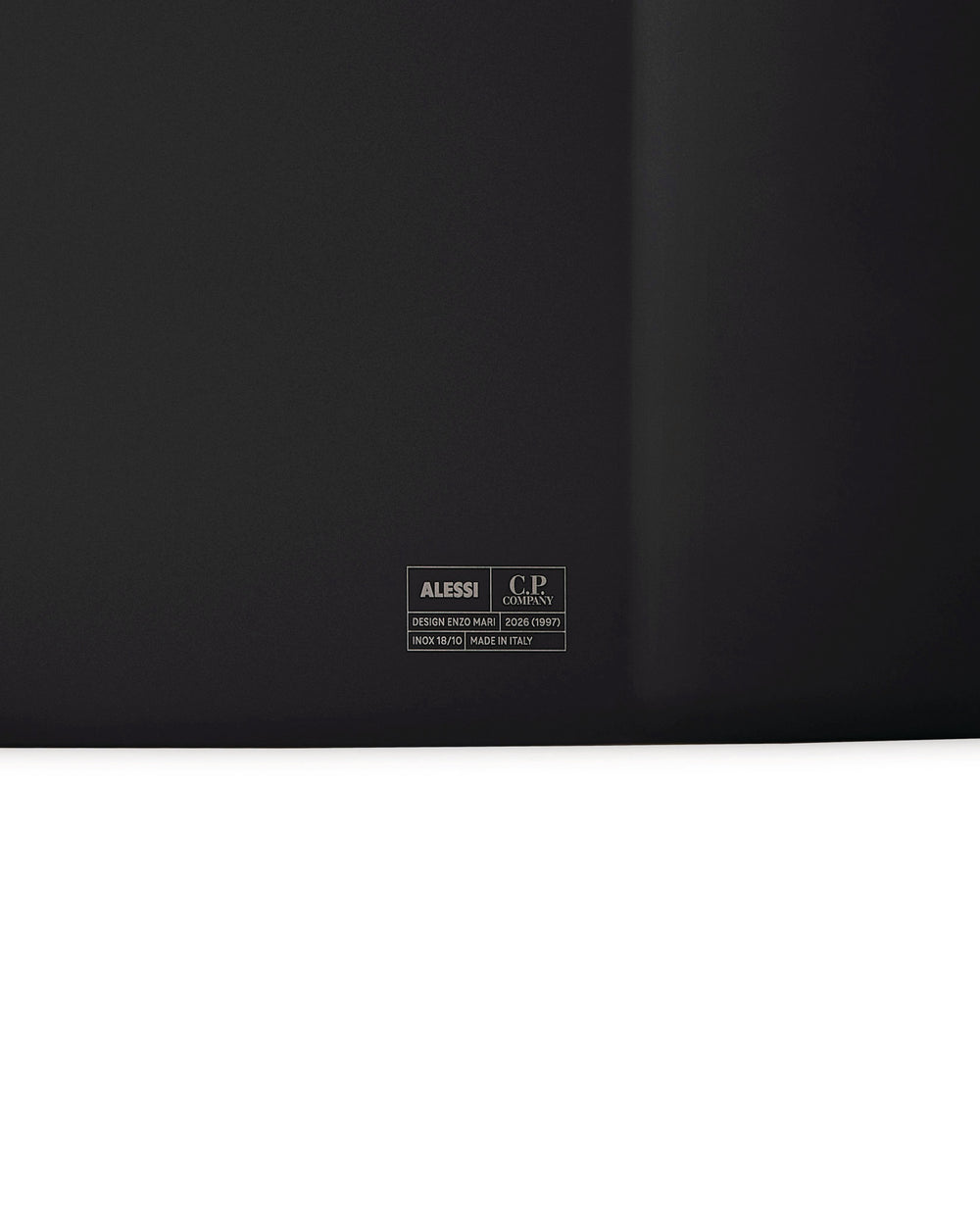 Dark grey inox tray by Alessi, featuring a C.P. Company logo and designer details engraved centrally.