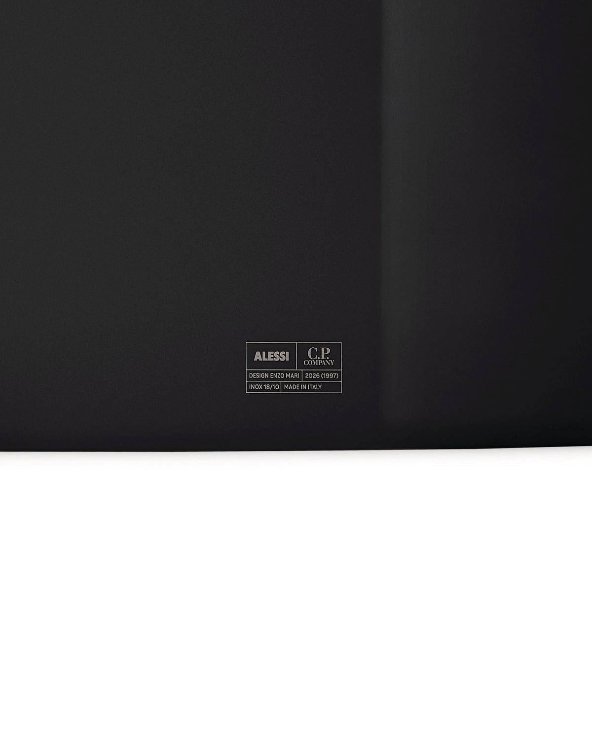 Dark grey inox tray by Alessi, featuring a C.P. Company logo and designer details engraved centrally.