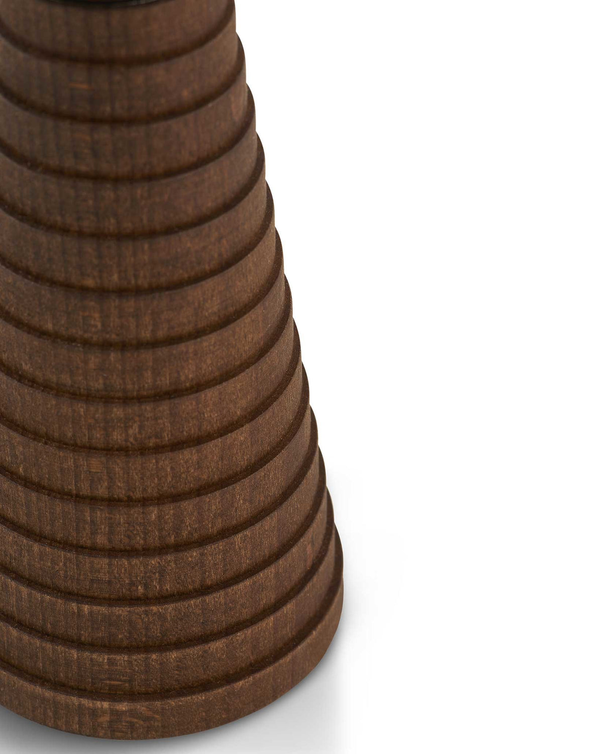 Dark brown wooden spice grinder by Alessi, with a ridged, stacked design, in a cropped close-up.