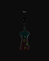Anna G. corkscrew by Alessi, with a smiling black head, dark teal body, and green 'TEMP' text on a reddish base, back view.