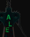 Dark teal and black corkscrew by Alessi with glowing green "ALE" letters and a subtle, textured pattern.