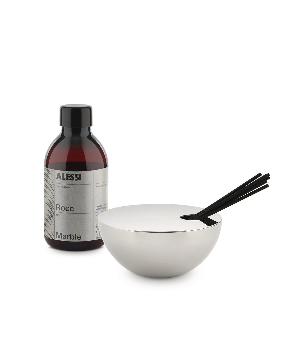 Silver bowl-shaped fragrance diffuser by Alessi with black sticks and a brown refill bottle.