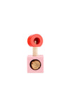 Wooden nutcracker by Alessi with a red ring handle and a pink cube base holding a walnut.