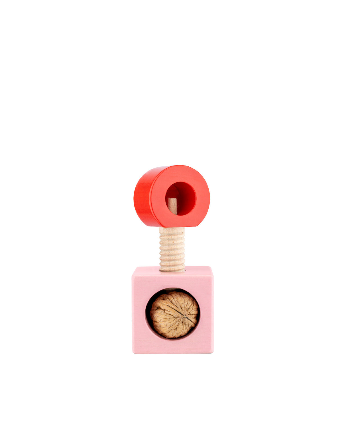 Wooden nutcracker by Alessi with a red ring handle and a pink cube base holding a walnut.