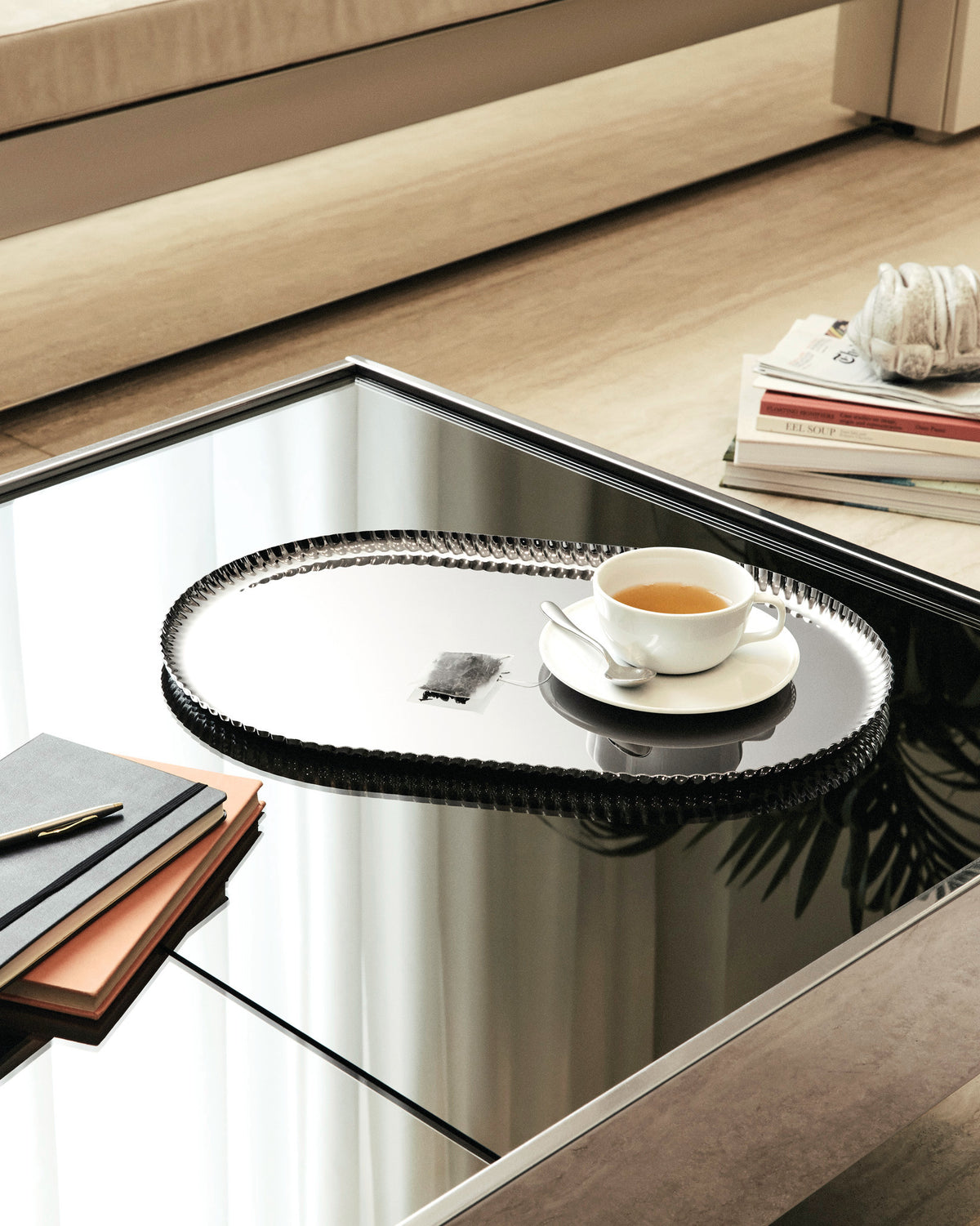 Silver oval Pleats tray by Alessi, featuring a decorative scalloped edge.