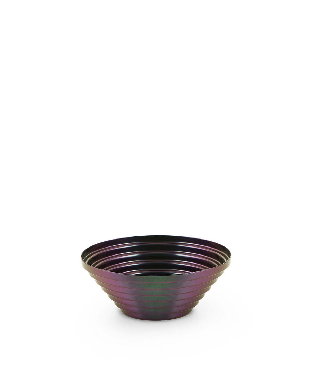 Iridescent dark purple and green metal bowl by Alessi with a ribbed, layered design.