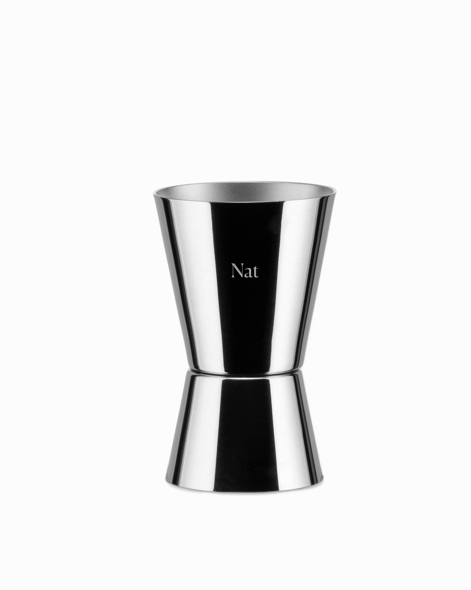 Polished silver double-ended jigger by Alessi, engraved with 'Nat'.