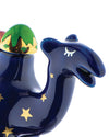 Glossy blue nativity camel figure by Alessi with gold stars, a green and gold patterned hump, and a stylized closed eye.