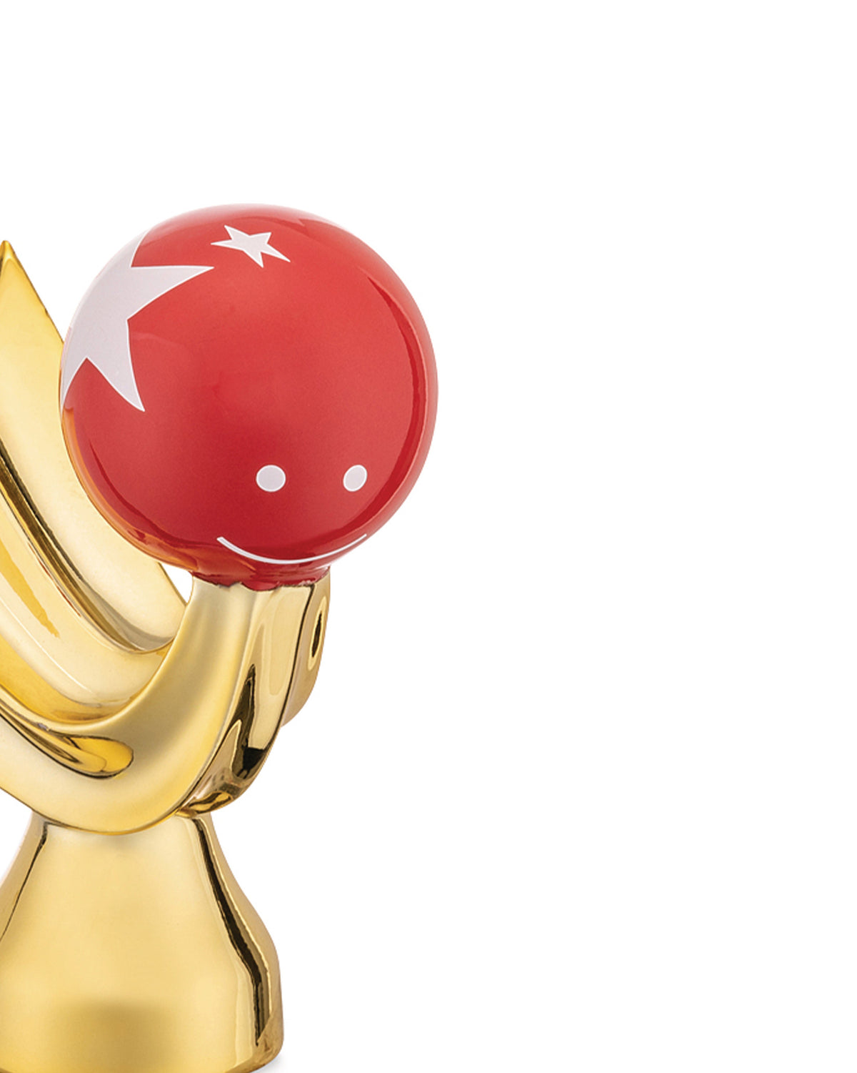 Red and gold Happy Eternity Baby nativity figure by Alessi, with a white star, crescent, and smile.