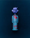 A turquoise figure corkscrew with red patterns by Alessi, featuring a detachable silver dragon head.