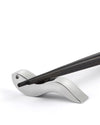 Dark wooden chopsticks by Alessi, resting on a sleek silver metallic holder.