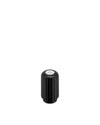 Black ribbed capsule crusher by Alessi with a silver circular top.