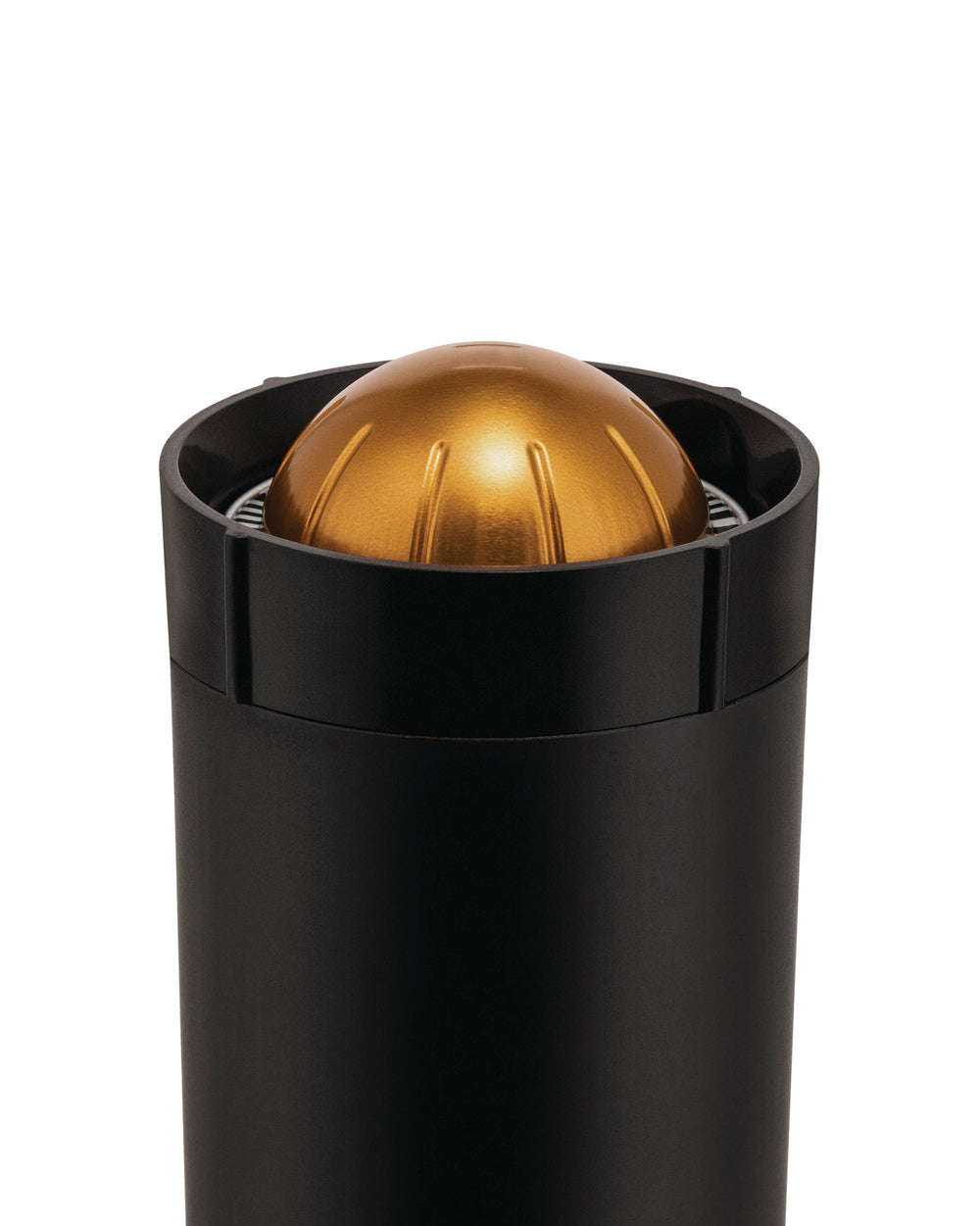 Black capsule crusher with a gold top by Alessi, featuring a cylindrical body and a ridged, dome-shaped cap.